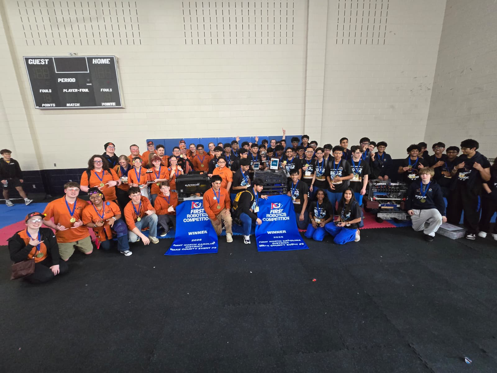 Large team photo with 2024 Wake County Event winner banners